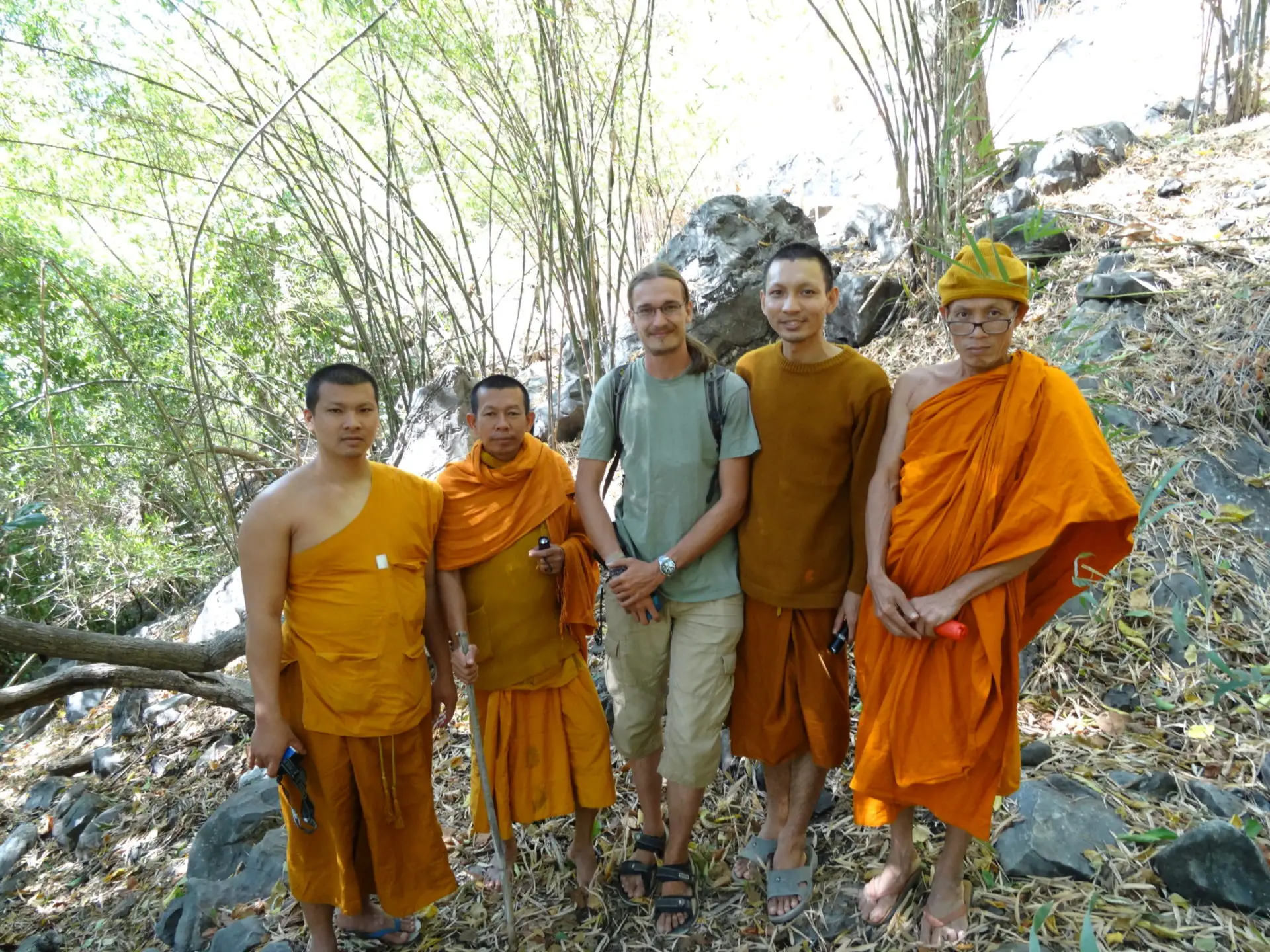 A traveller surrounded by four Buddhist Monks near Lopburi, Thailand