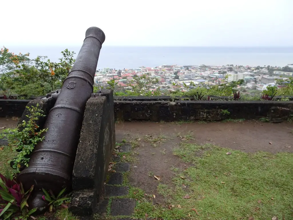 A cannon looking out over a city on Morne Bruce Hill in Roseau, Dominica