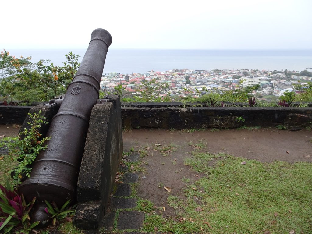 A cannon looking out over a city on Morne Bruce Hill in Roseau, Dominica