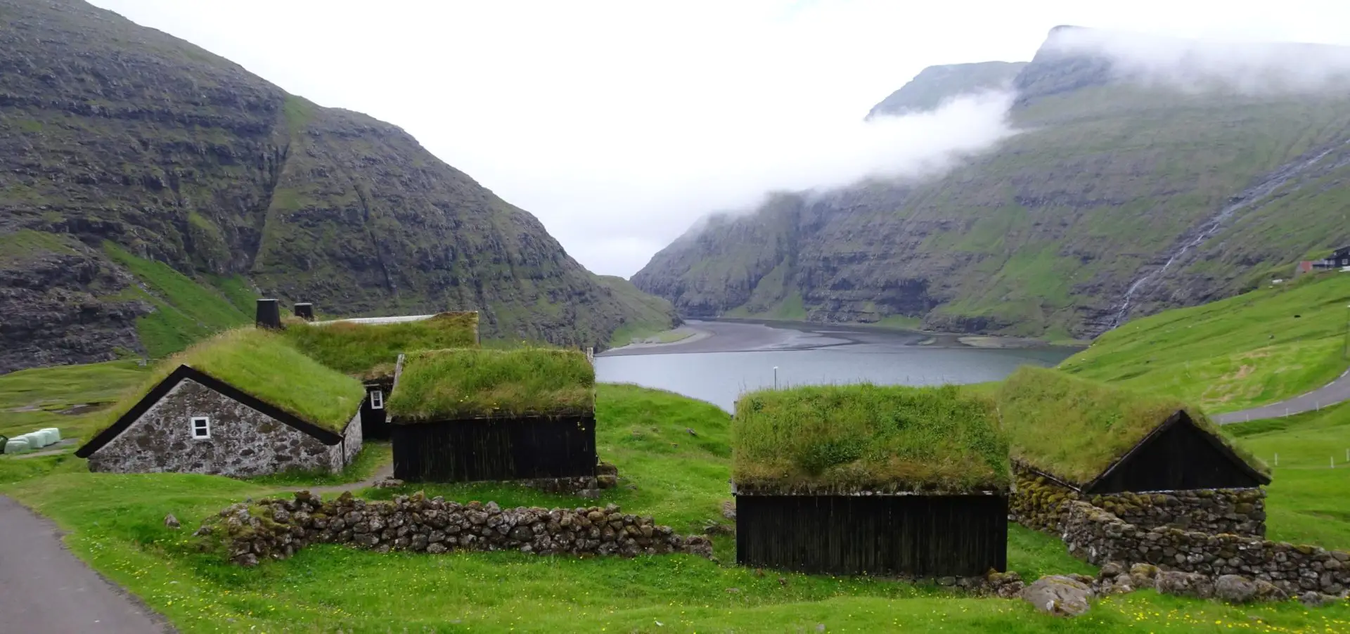 Grass-roofed buildings near the sea in Saksun, Faroe Islands