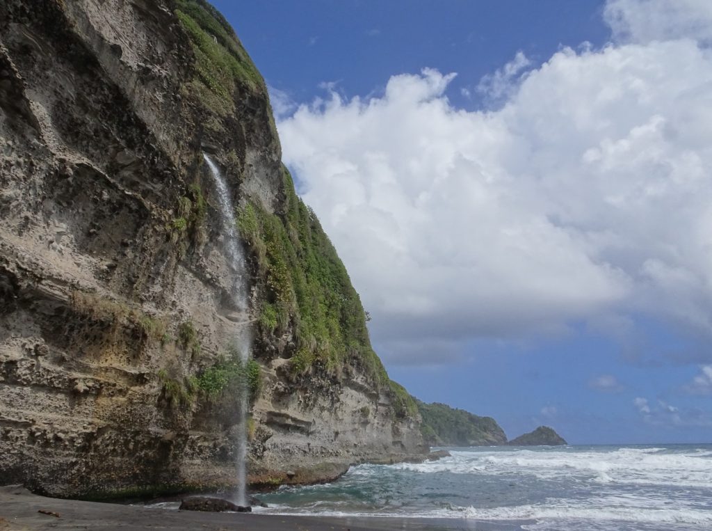 Wavine Cyrique, a waterfall falling of a cliff into the ocean on Dominica