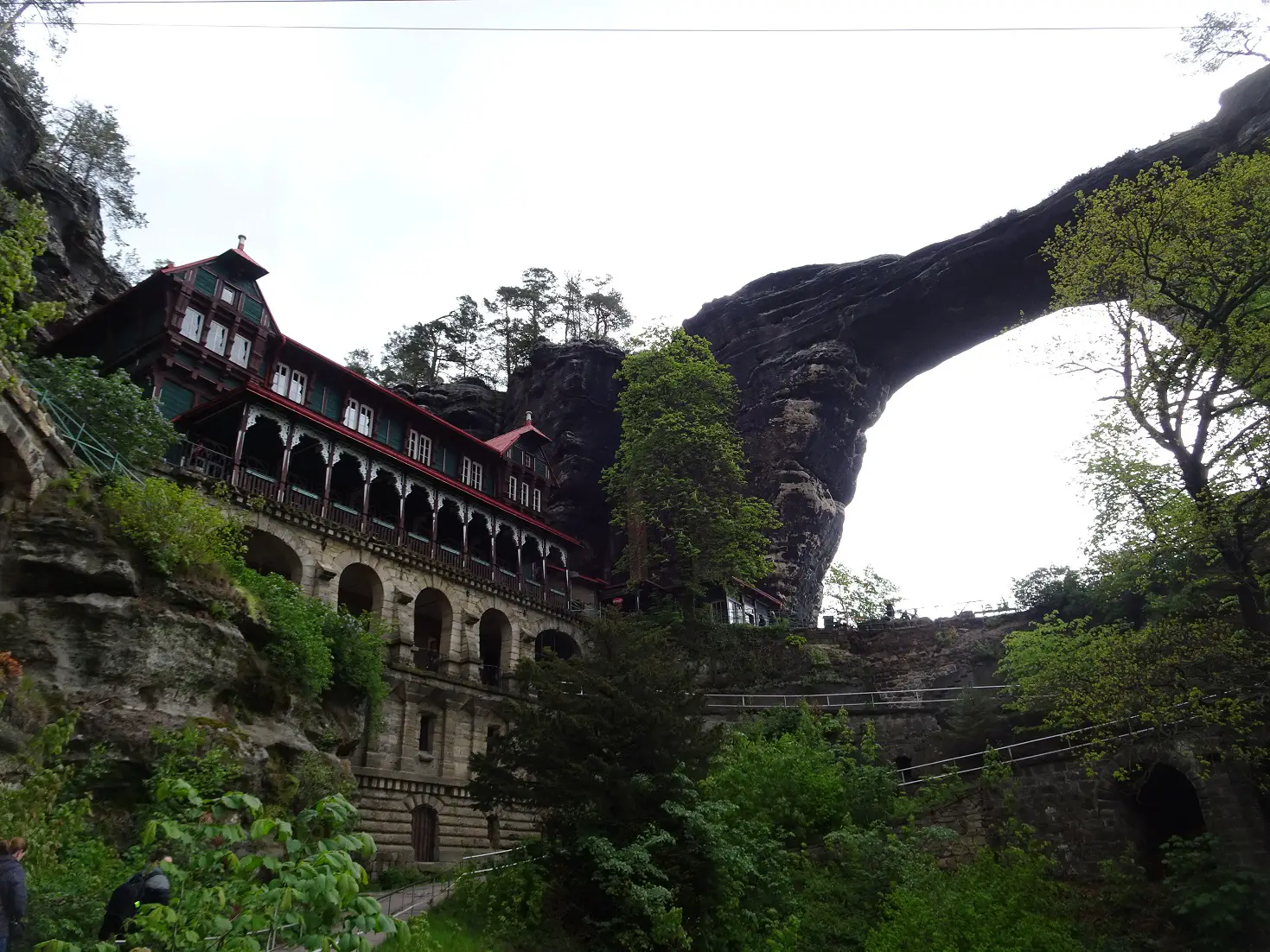 A wooden house under a Stone Arch in the Bohemian Switzerland