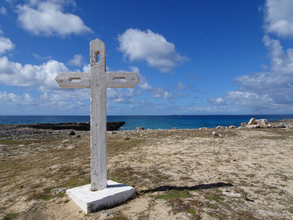 A white stone cross by the Ocean