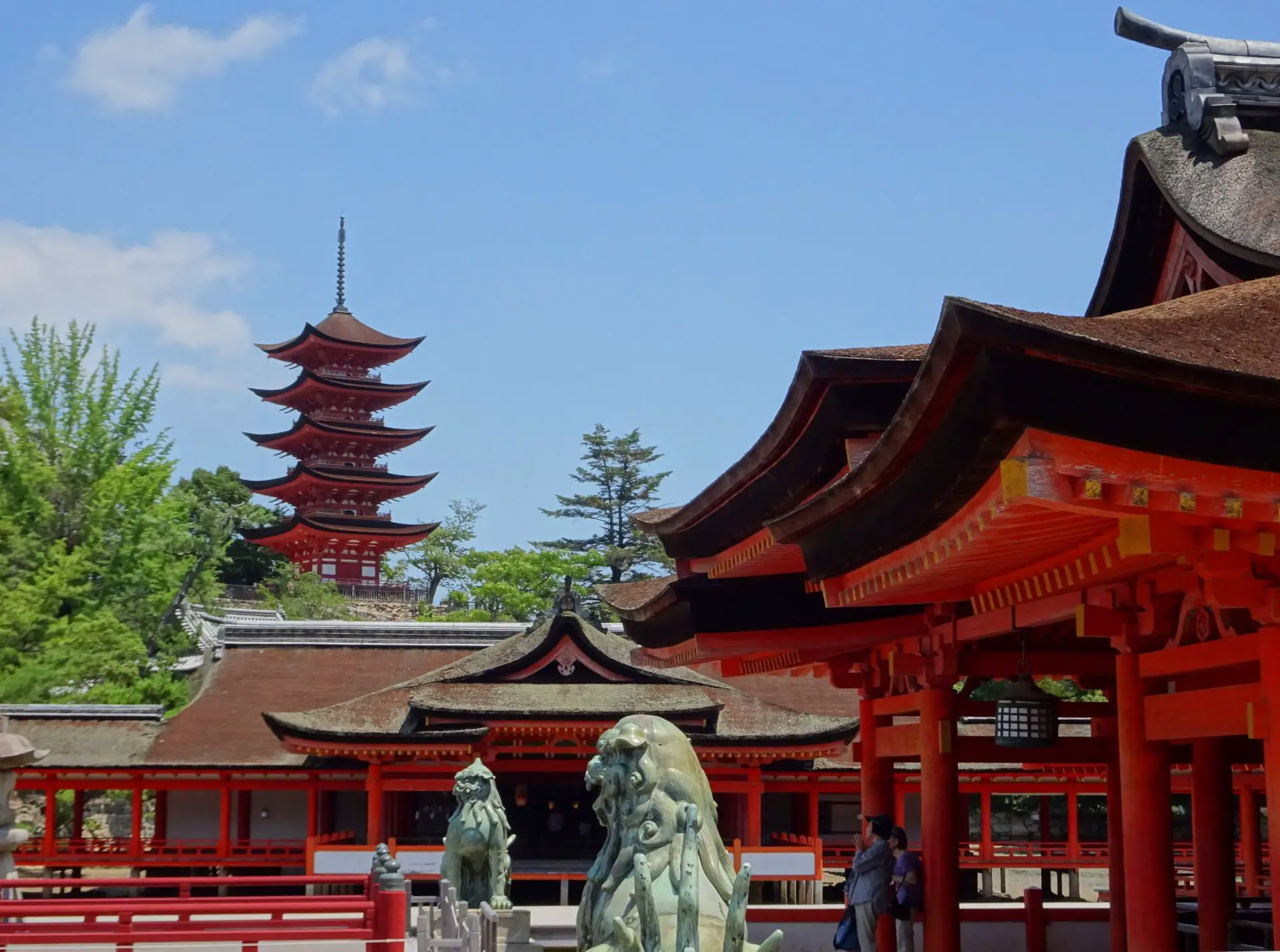 A five-storied pagoda seen over a group of red temple buildings