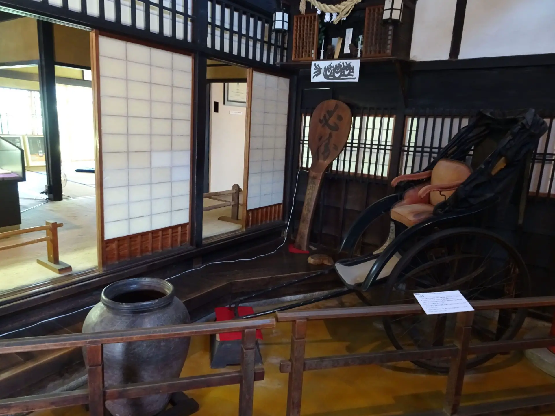 A wooden carriage displayed in a museum