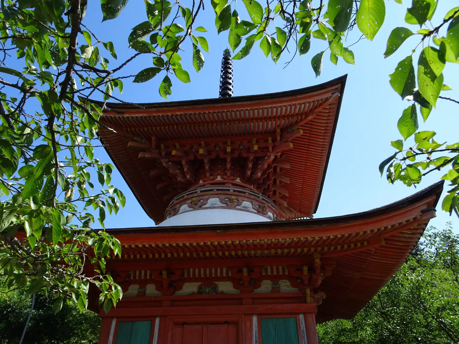 A small red pagoda surrounded by trees