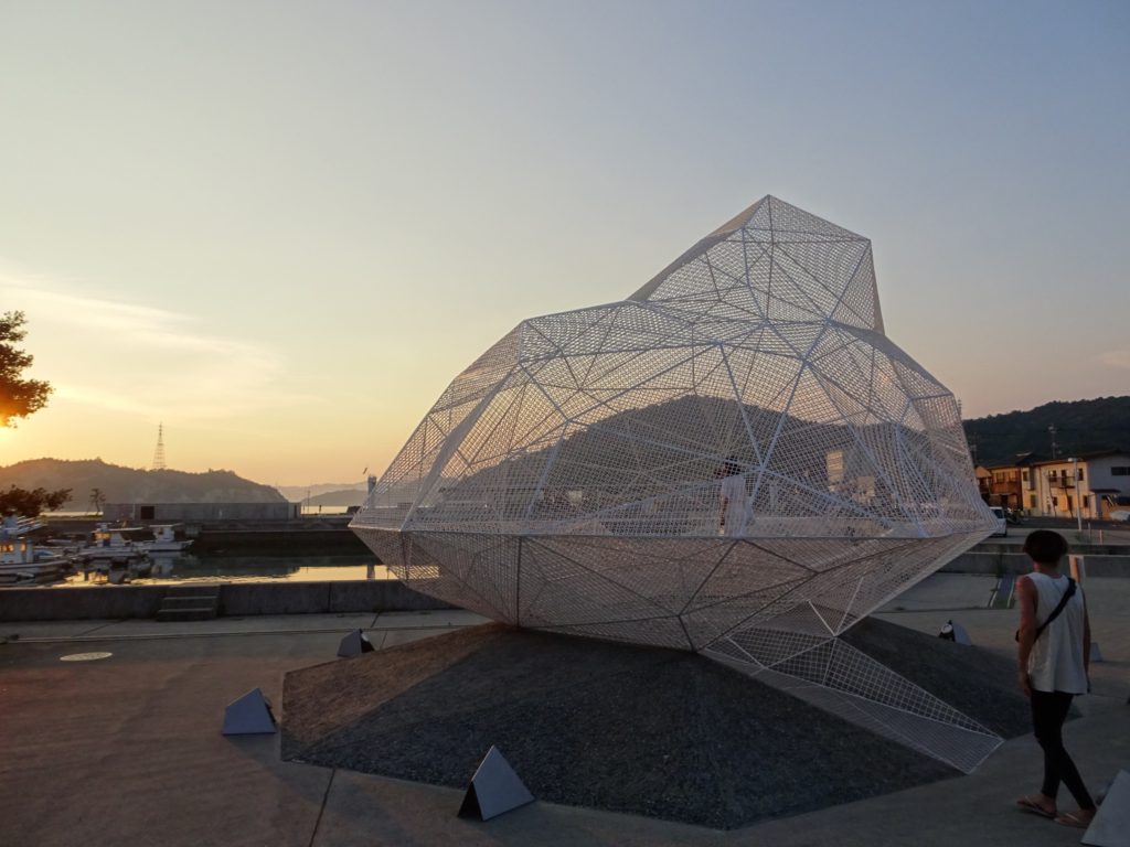 A cage like sculptire by the ocean