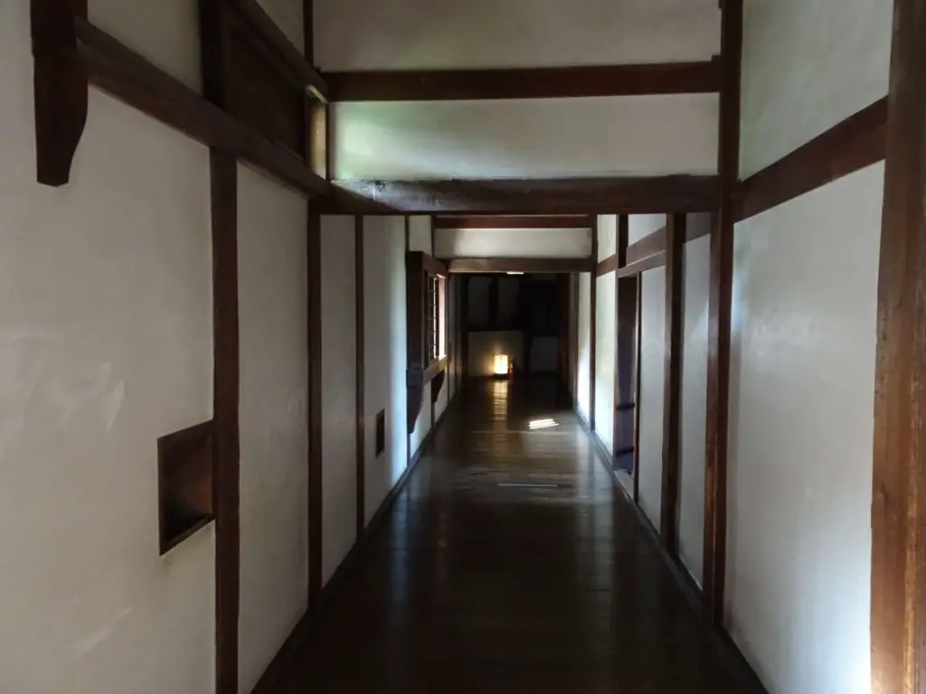 A wooden corridor with wall panels on both sides
