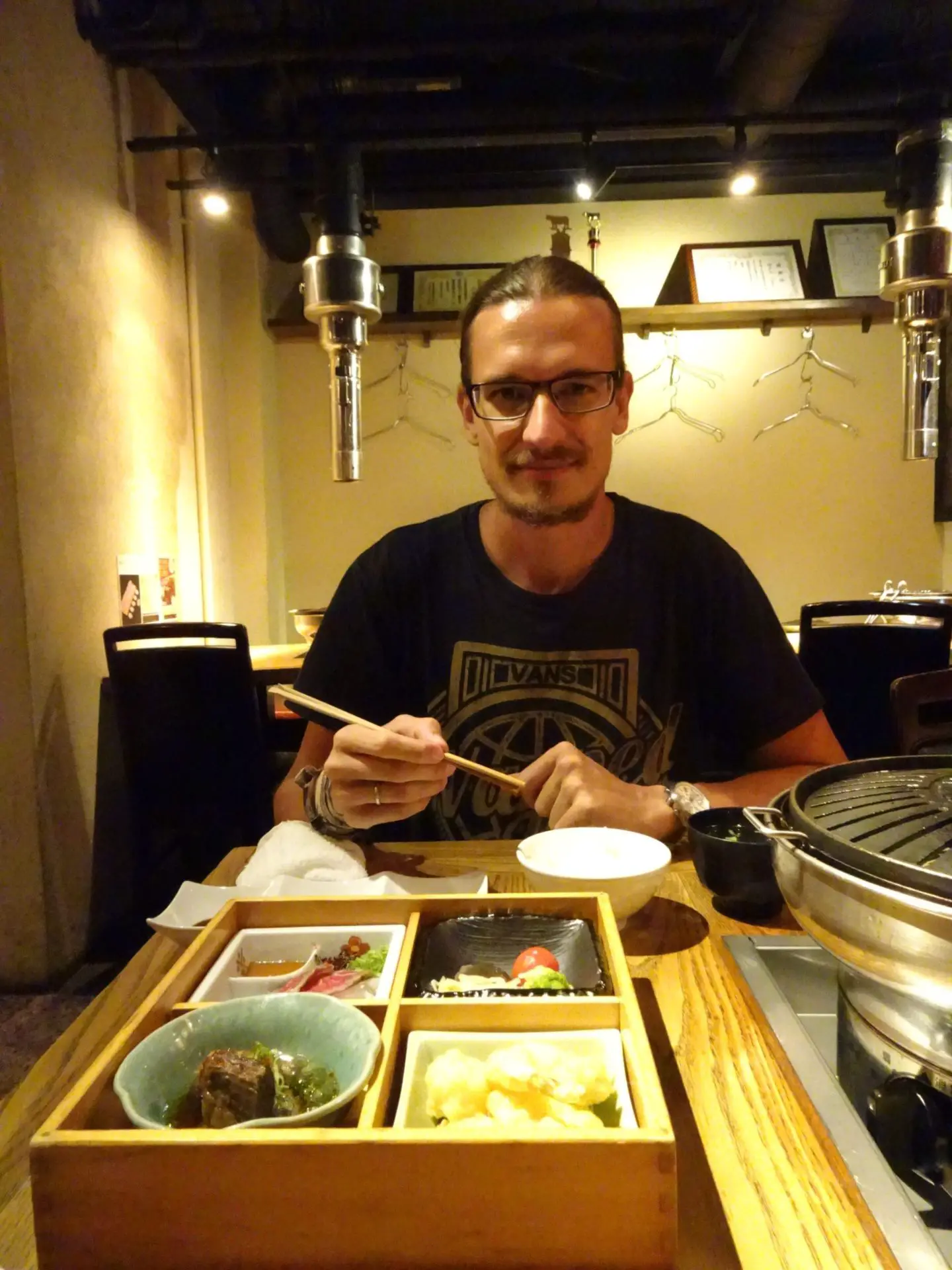 A man sitting in front of a plate Kobe Beef