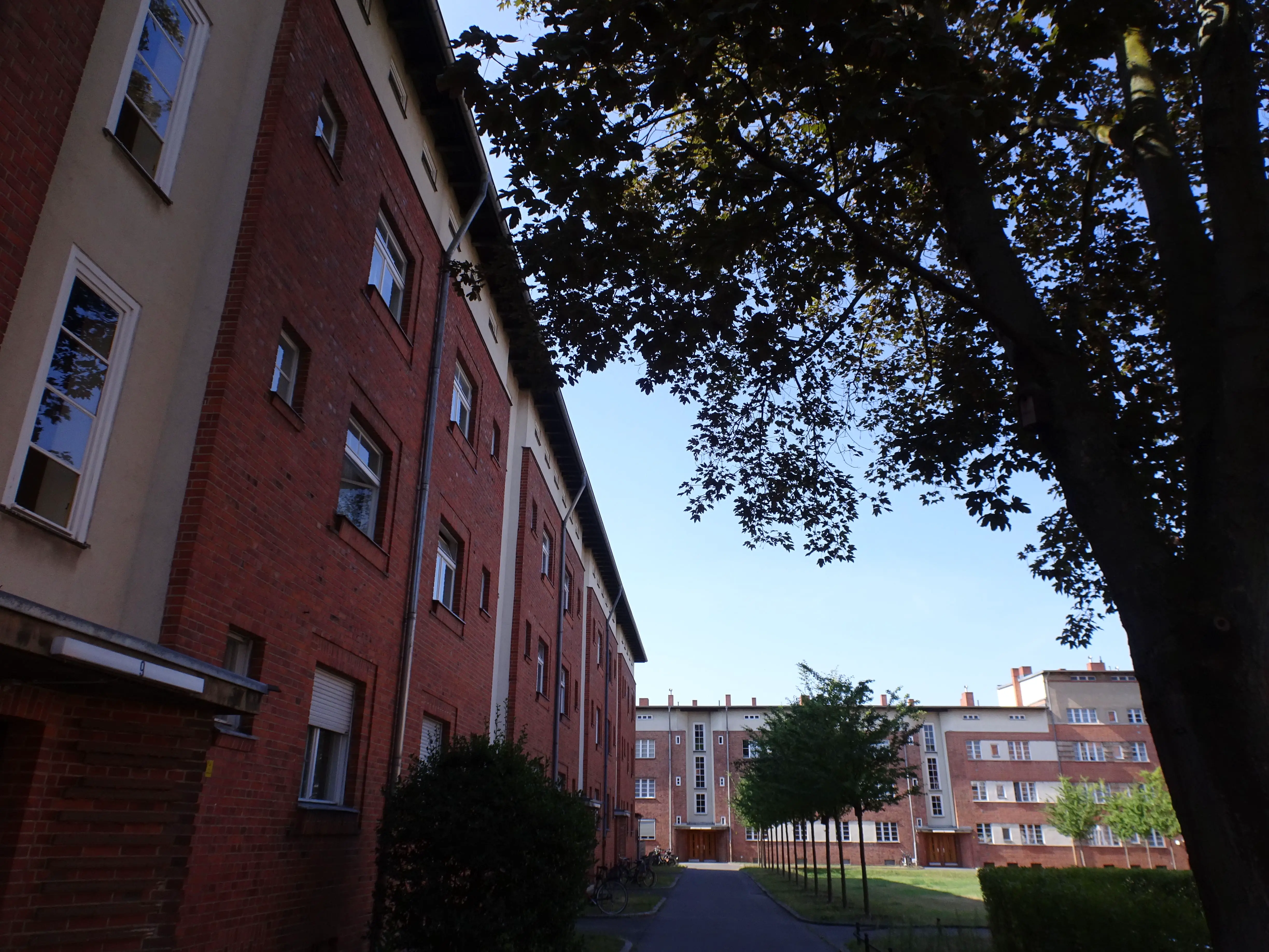 A housing estate surrounding a courtyard with trees