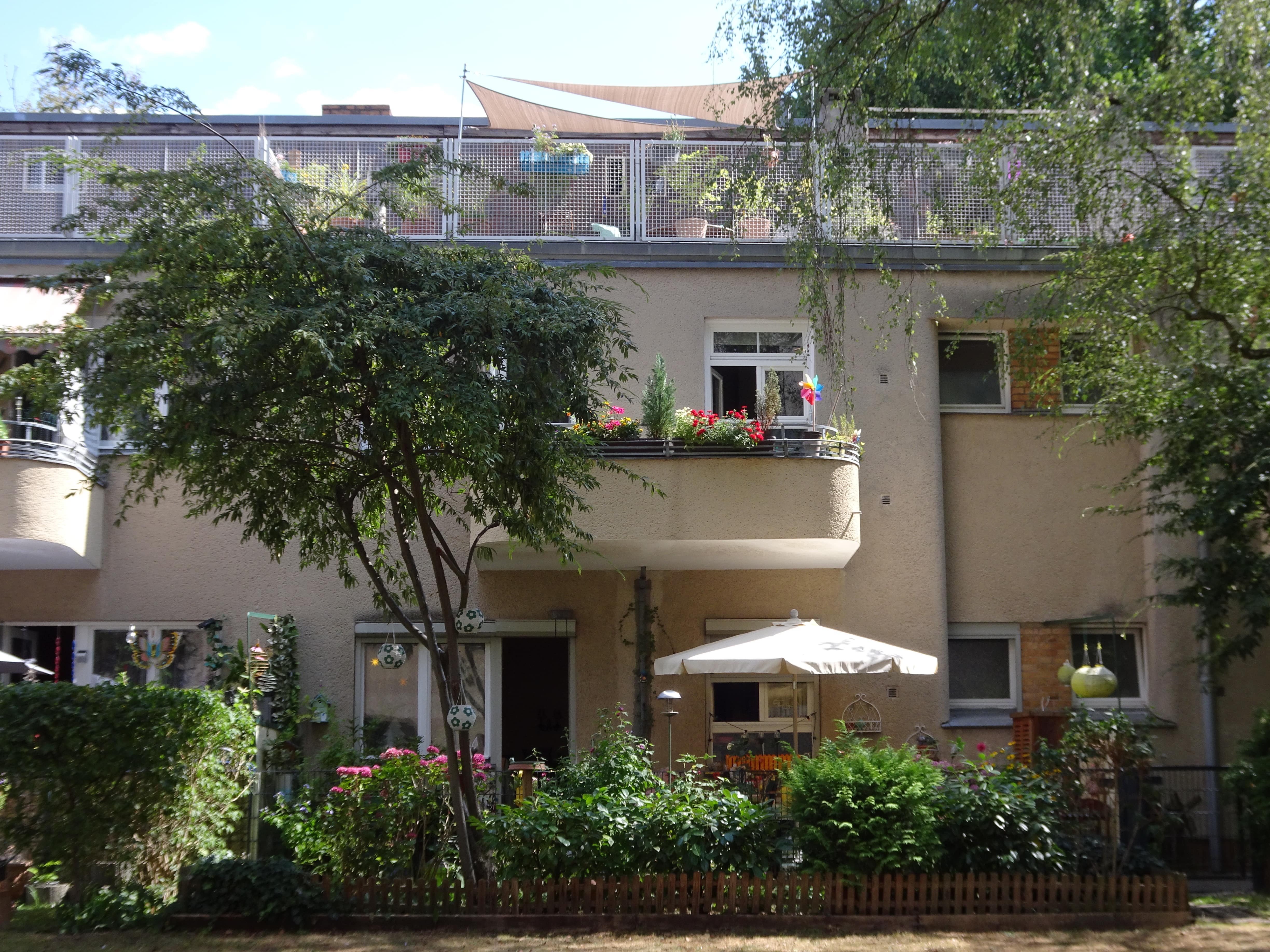 A house facade with flower-studded balconies