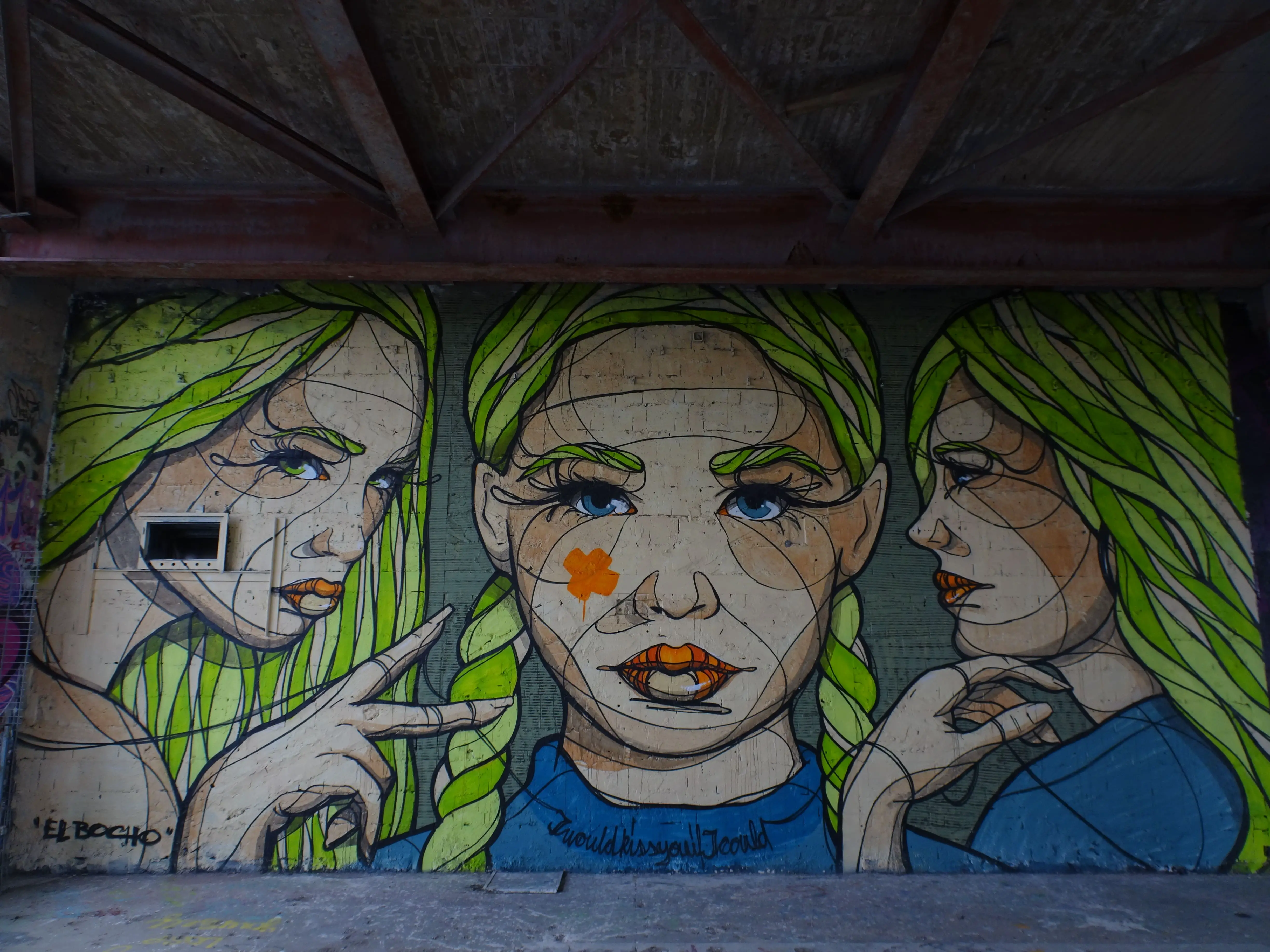 A wall-wide graffiti of three blond girls