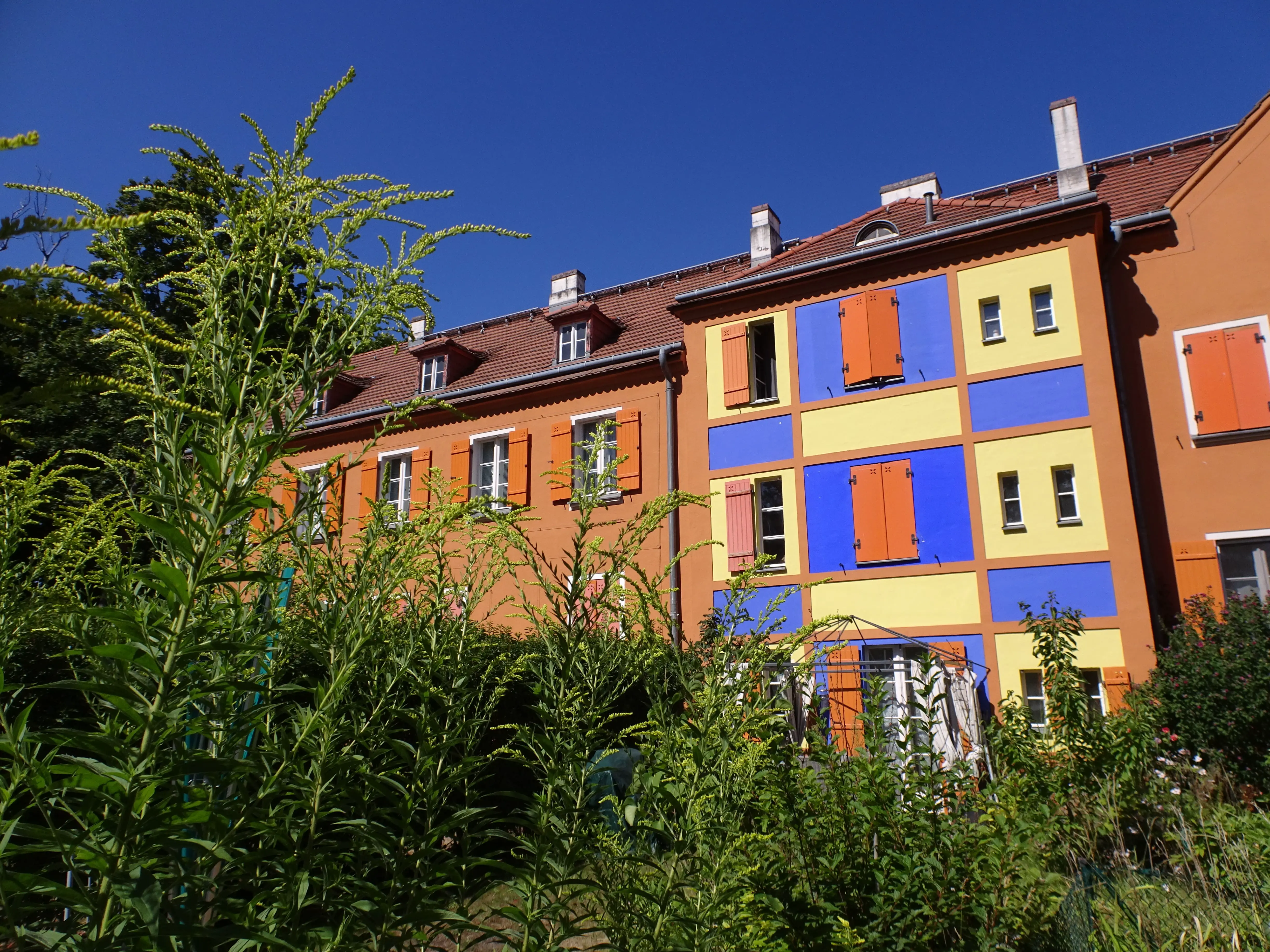 Brightly painted houses with flowery gardens