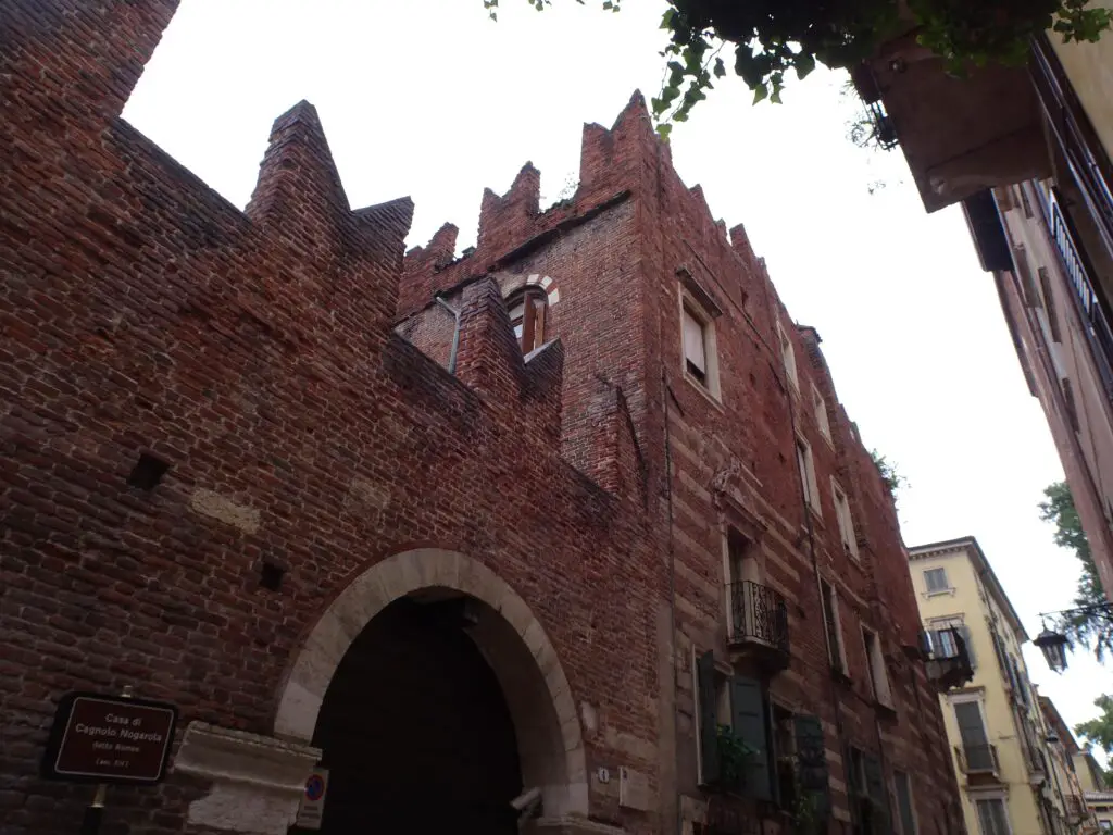 An imposing medieval palace in a small alleyway