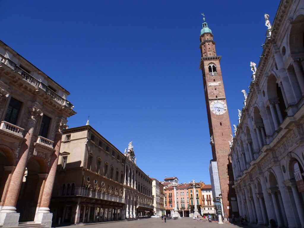 A market square full of palace buildings with a high tower