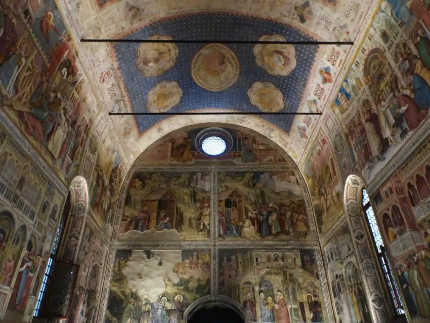 A chapel covered in countless frescoes with stars painted on the ceiling