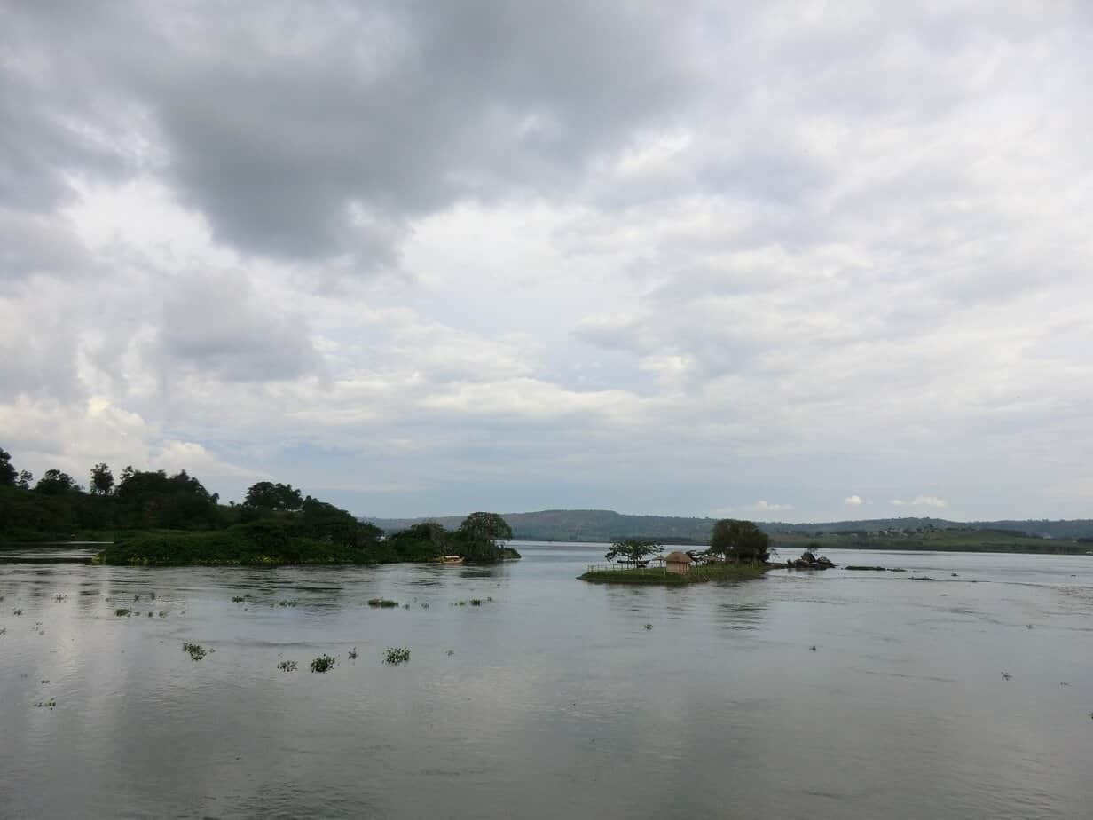 A big river flowing out if a lake with little islets in the middle
