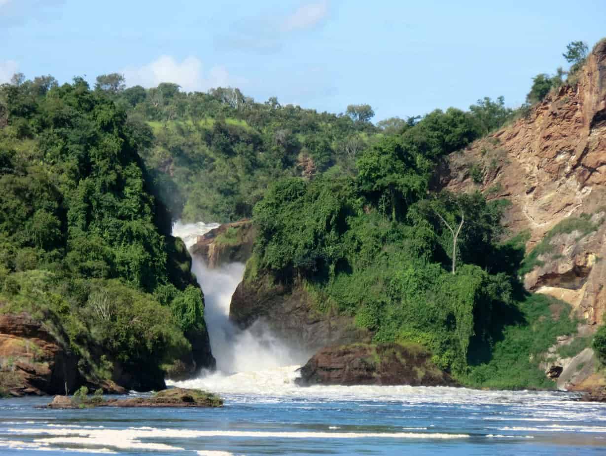 A powerful waterfall surrounded by tropical vegetation