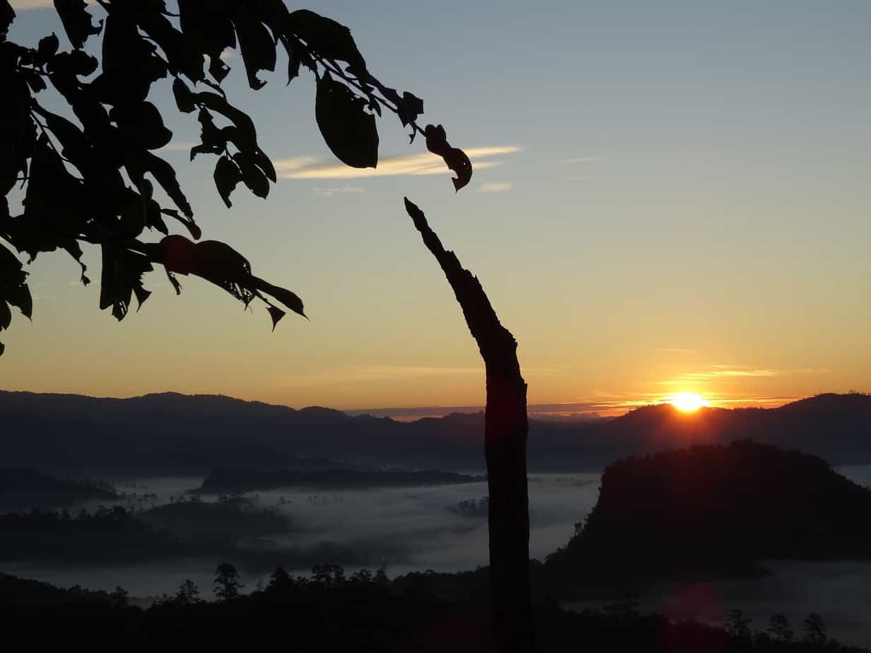 The sunrise over mountains and valleys filled with morning mist