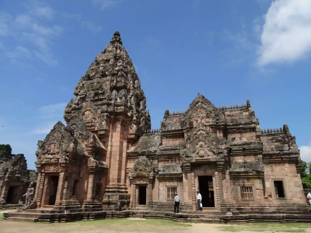 A intricately carved stone tower and temple building in the Khmer-Style