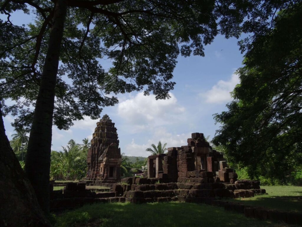 A small Khmer ruin surrounded by trees