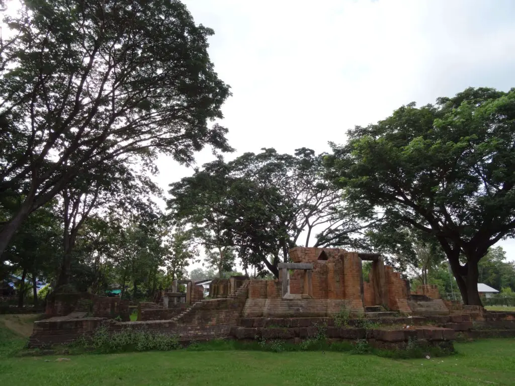A small Khmer ruin surrounded by trees