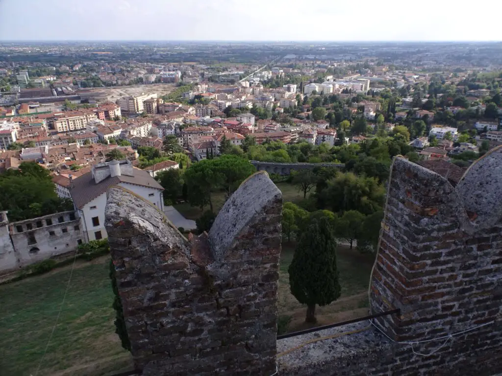 A small town seen above the parapet of a medieval tower