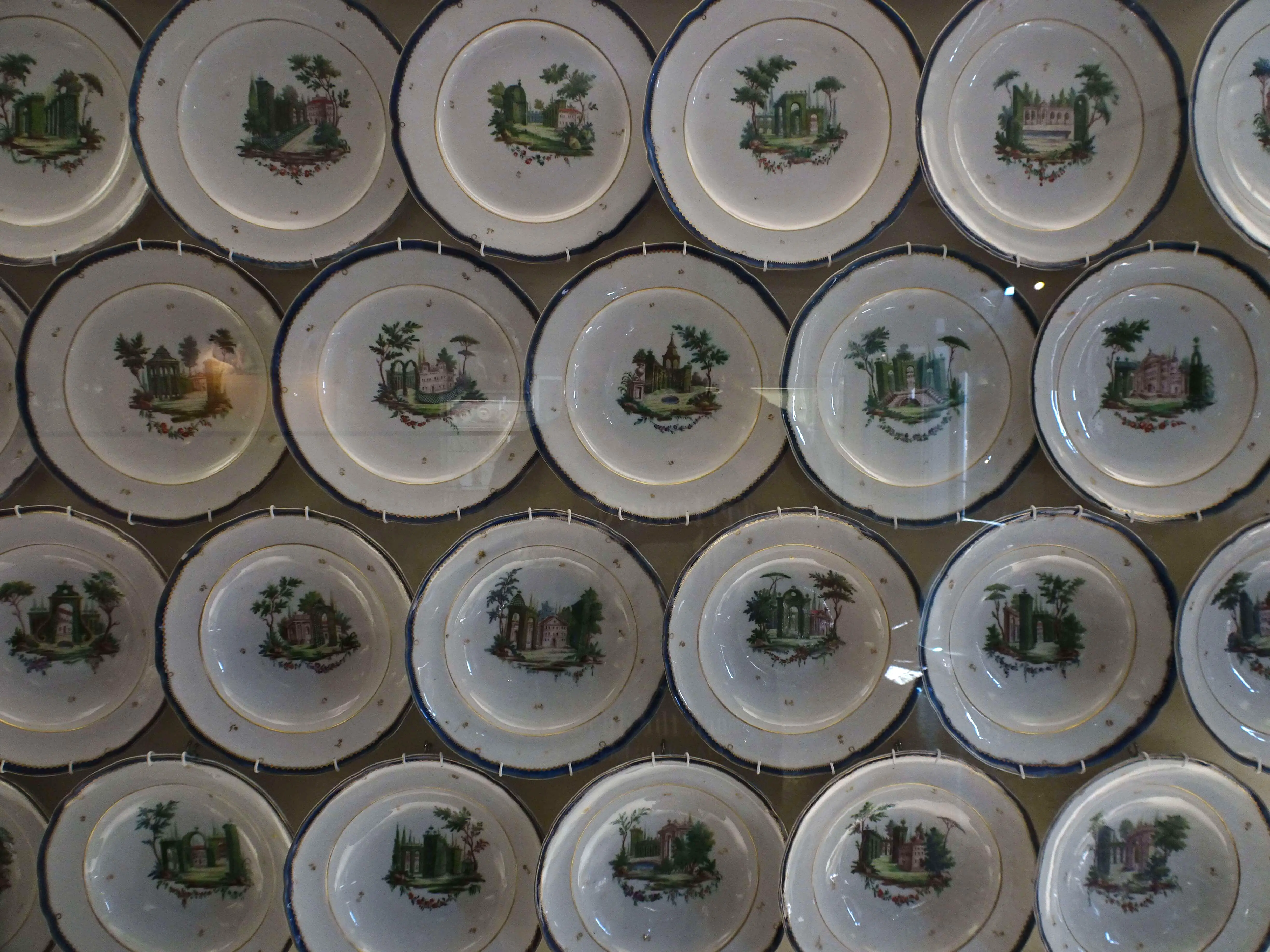 A glass display of ceramic plates