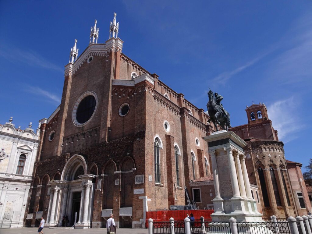 A big church with the statue of a man on horseback in front