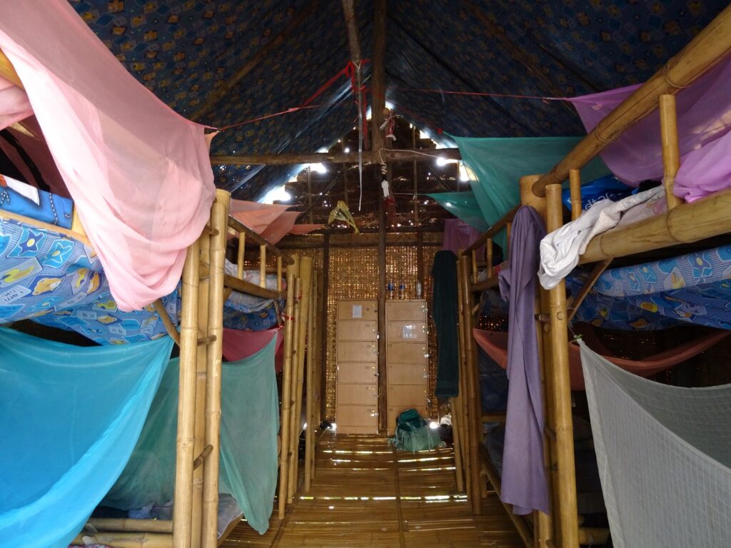 A rustic hostel dormitory in a reed-walled house