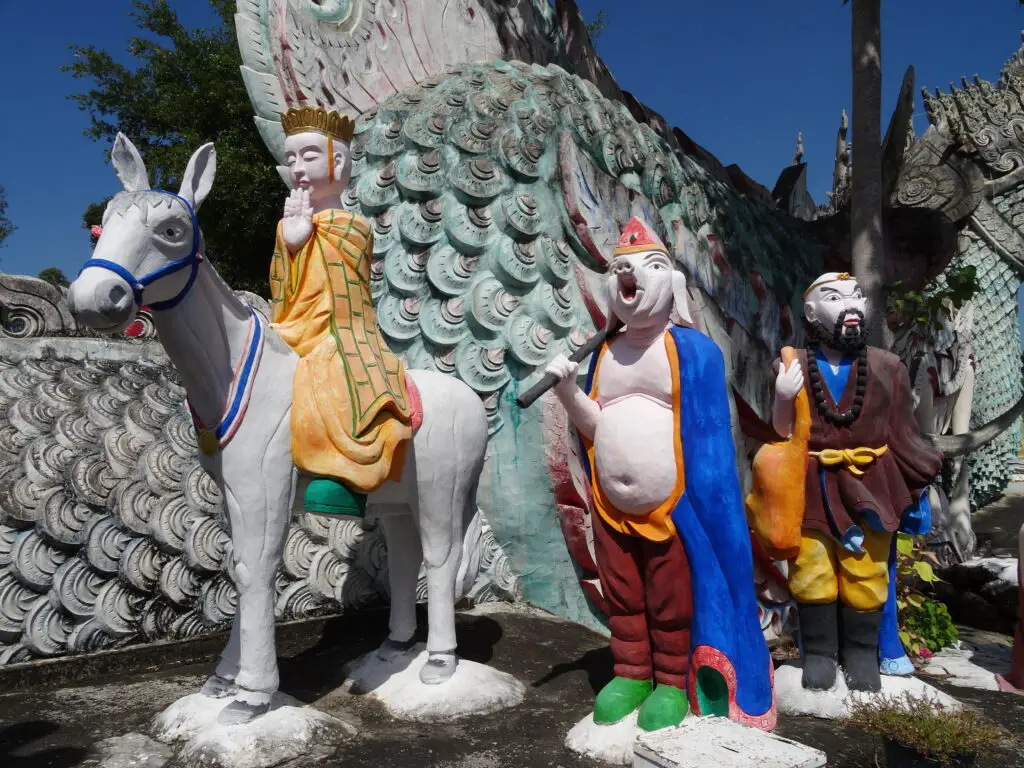 Statues of an anthropomorphic pig and a man riding a donkey