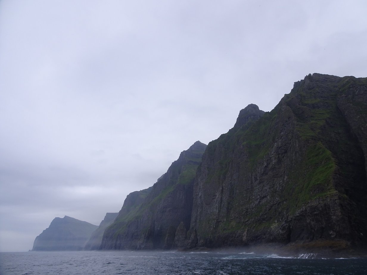A series of tall cliffs rising dramatically from the sea