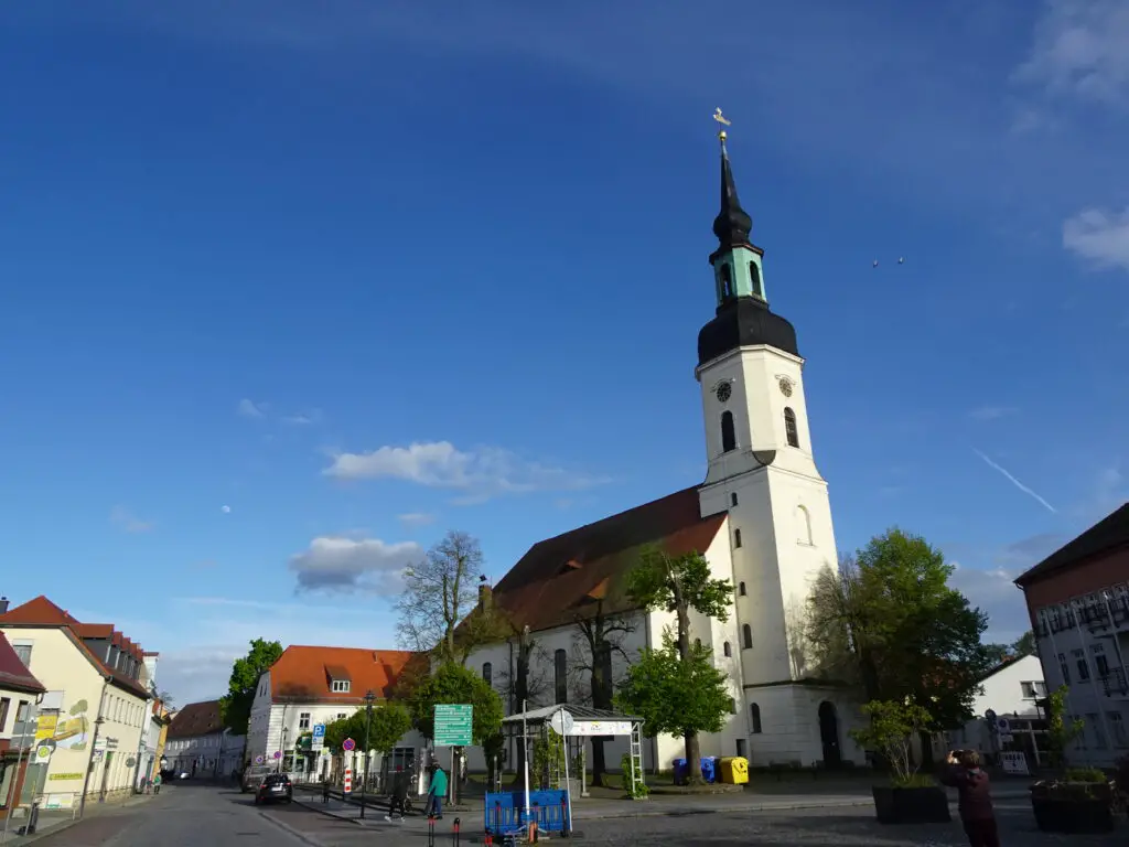 A baroque church towering over a small market square