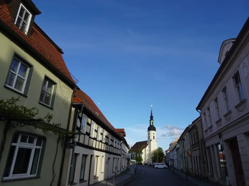 A street full of historic houses centred on a baroque church building