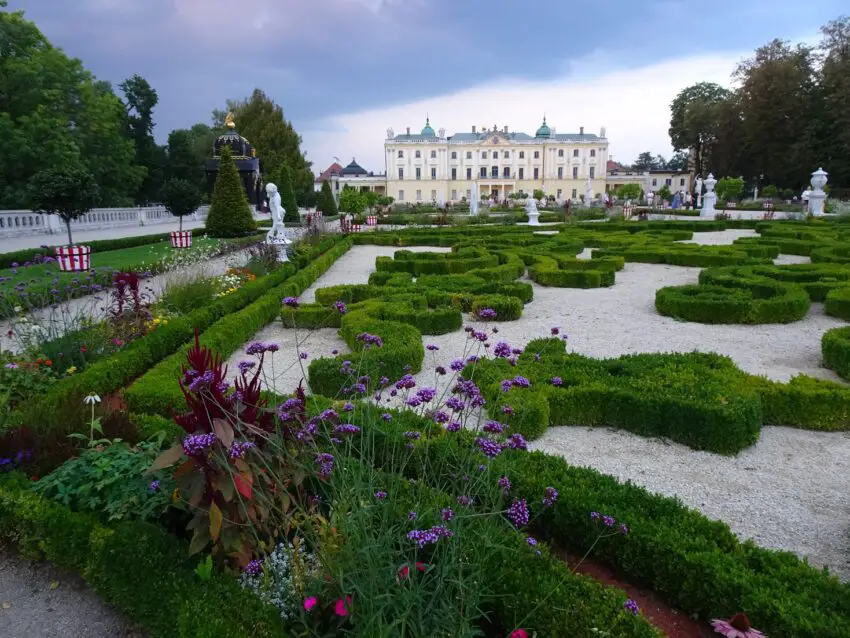 A baroque garden with a palace in the background