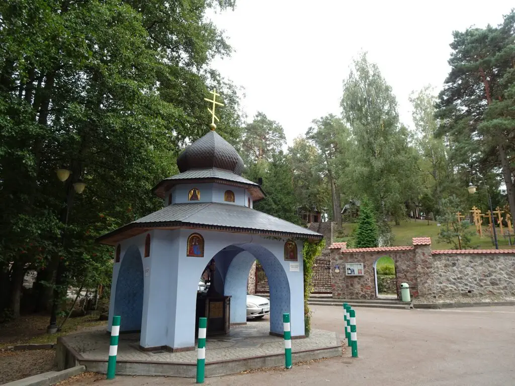 A blue-painted pavilion with a golden cross on the roof