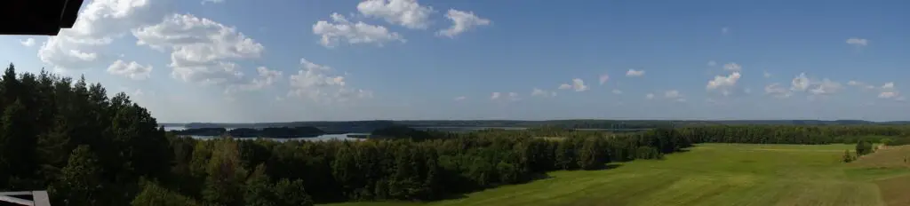 A panoramic view of a lake surrounded by trees seen from above