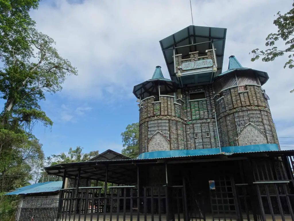 A castle-like building constructed from plastic bottles