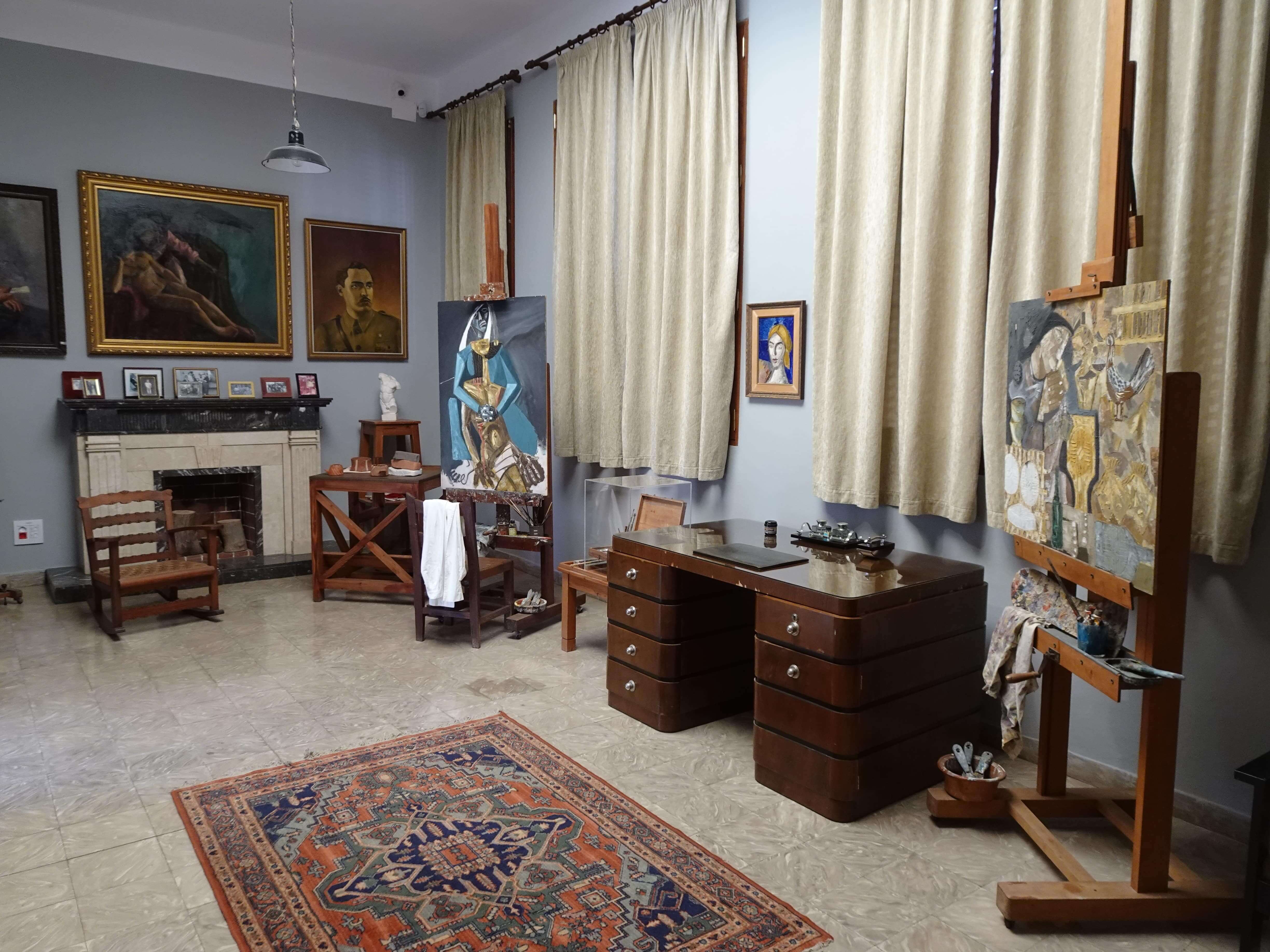 An artist's studio with furniture and paintings