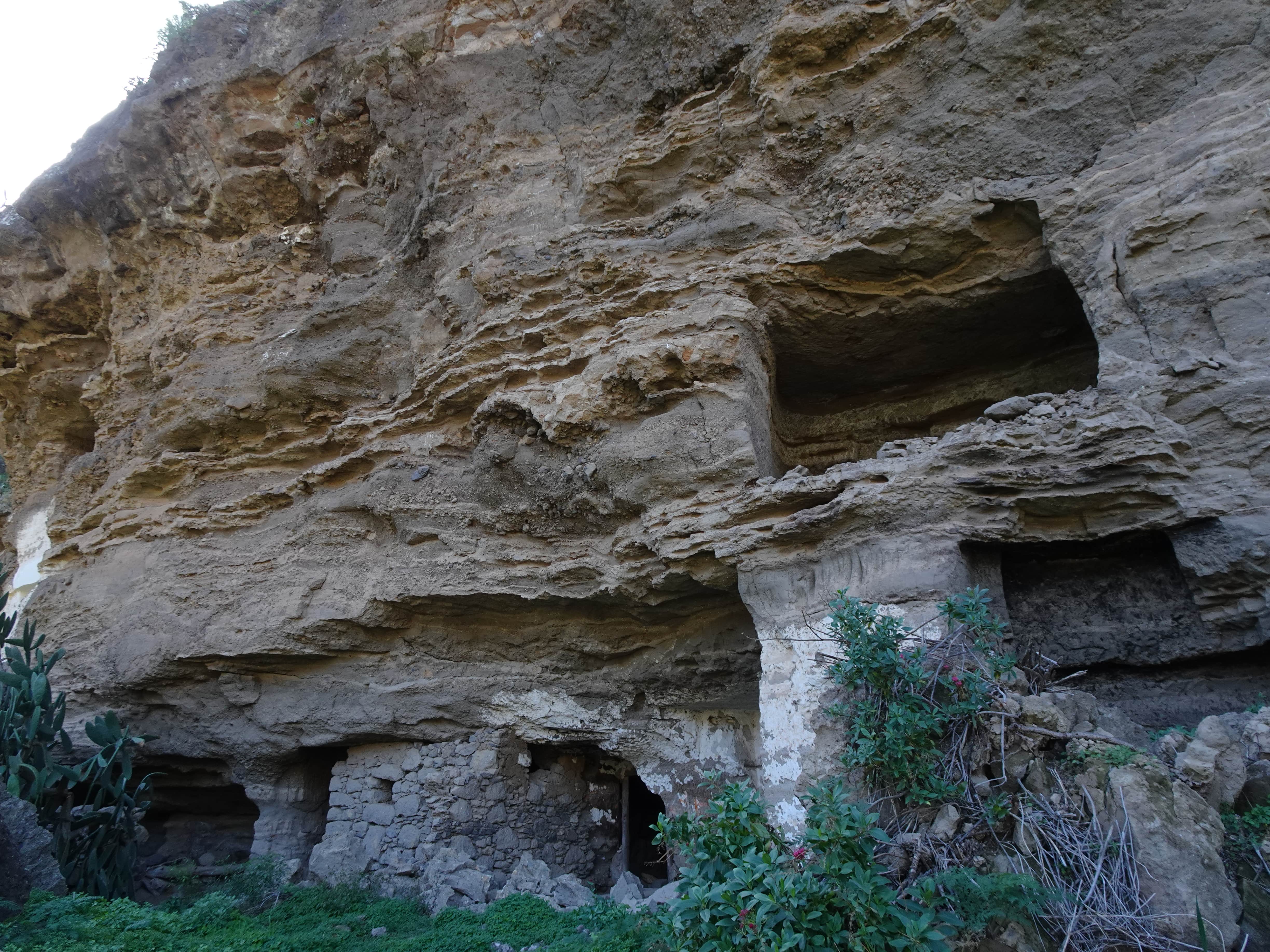 A cliff with several artificial cave-homes cut in the side of it