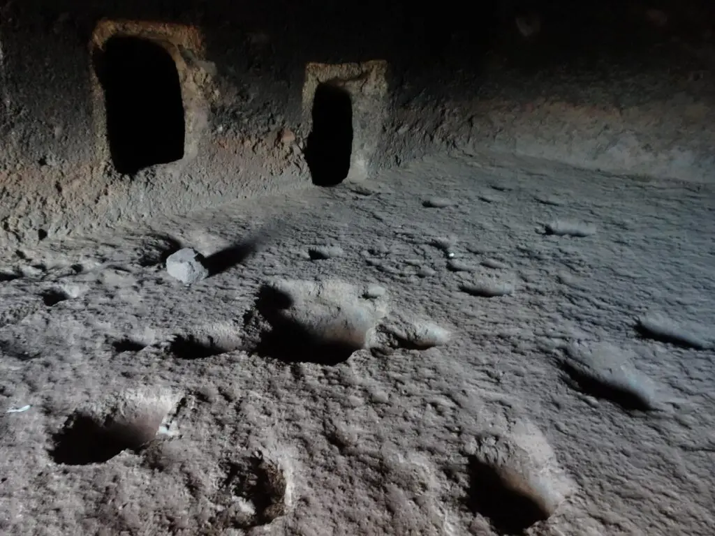 A prehistoric cave with artifical rooms and depressions dug in the ground