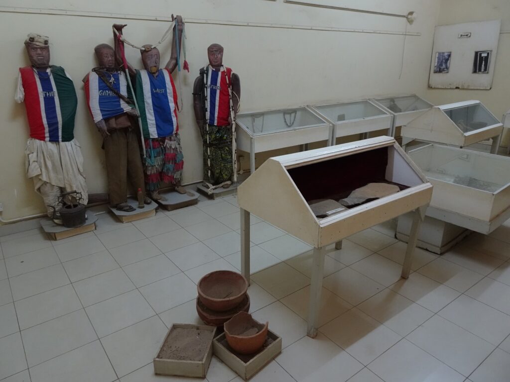 An exhibition room full of old display cases and styrofoam figures