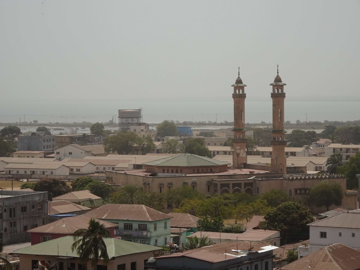 Two tall minarets towering over a small town