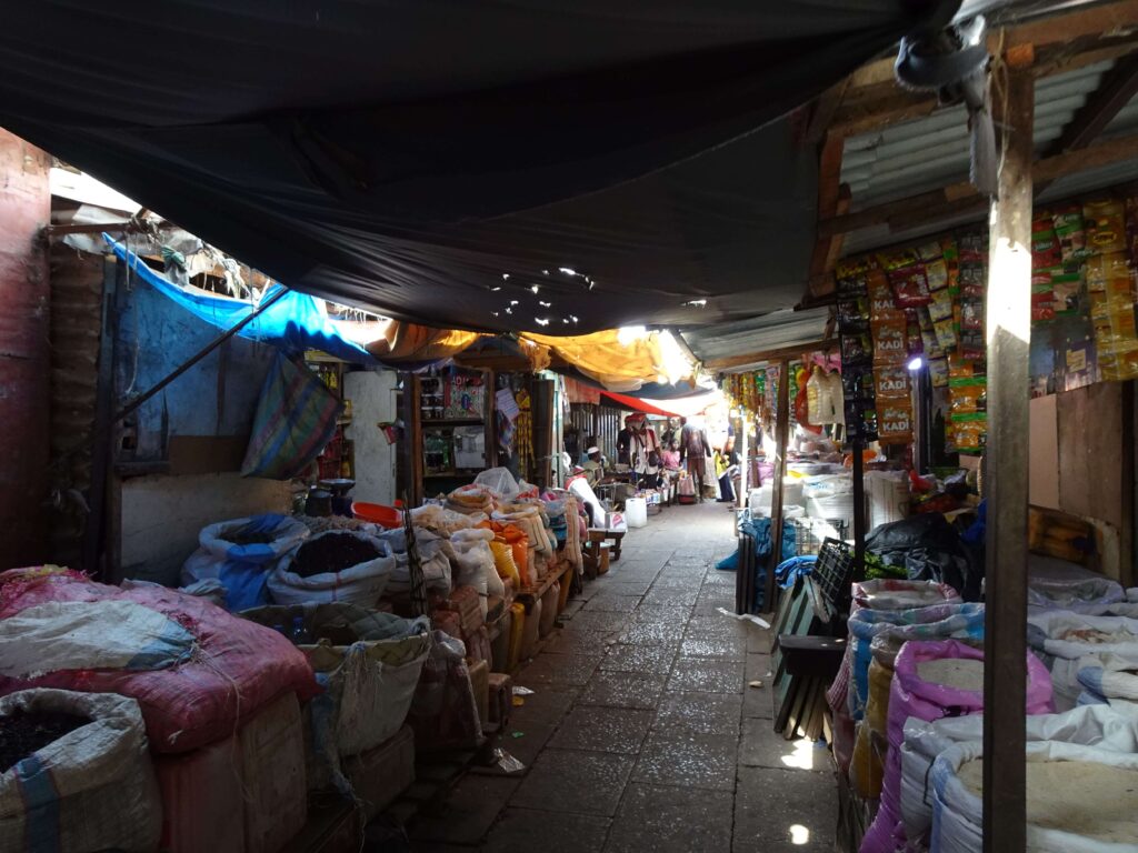 An alleyway of market stalls selling clothes
