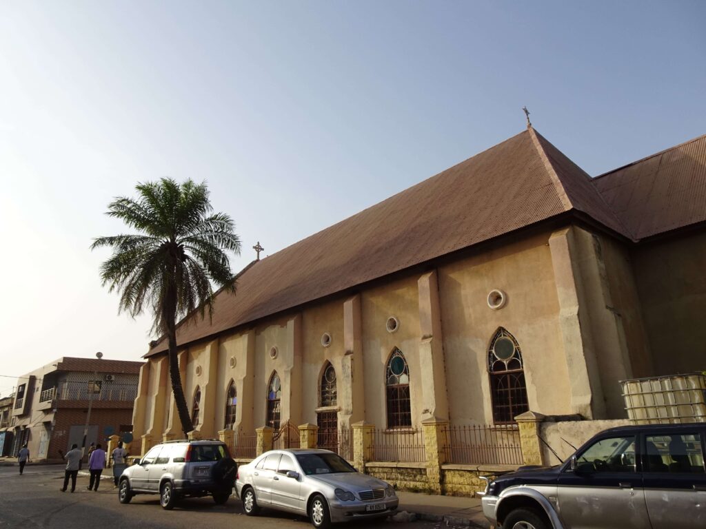 A big church with a palm tree to the side