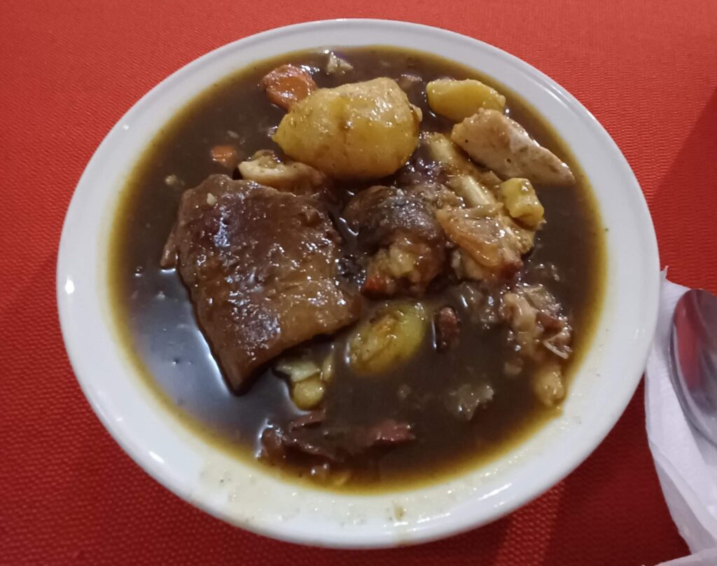 A thick soup with potatoes and pieces of meat
