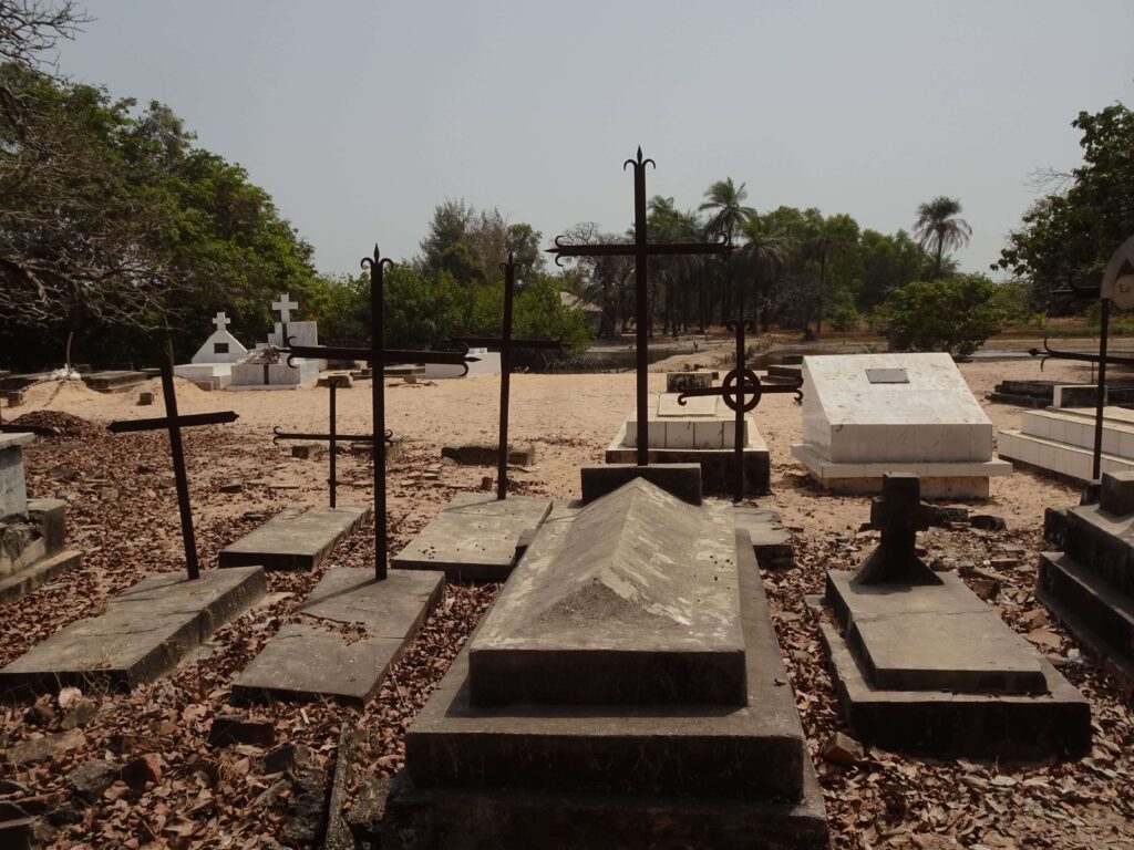 A series of old graves in a cemetery by the beach