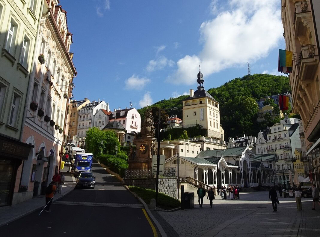 A city street with a castle tower in the background