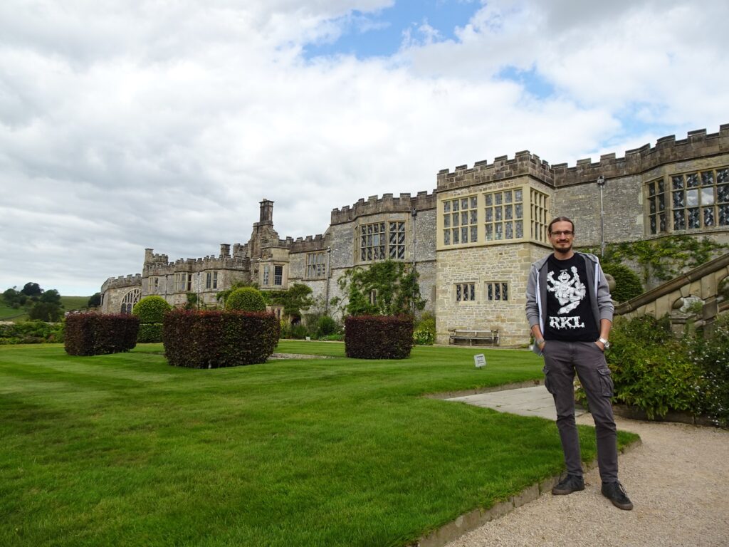 A man standing in the courtyard of a medieval country house