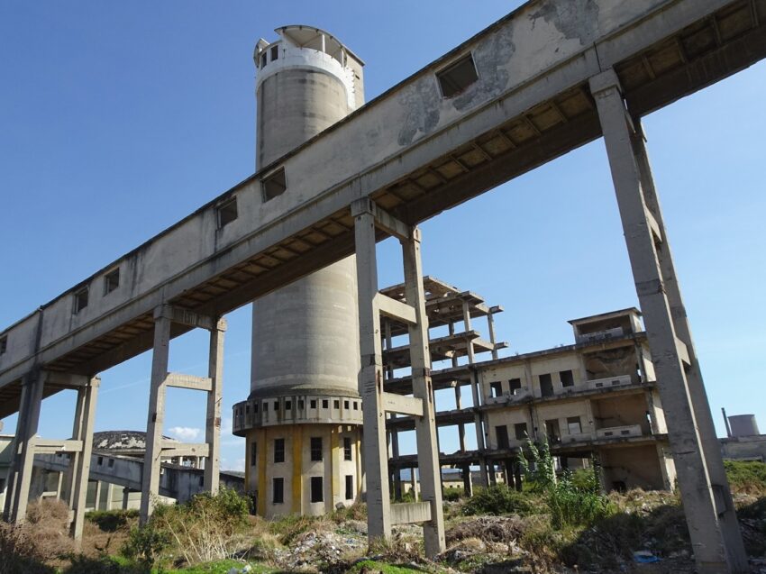 Towers, buildings and a covered walkway at an abanoned power plant